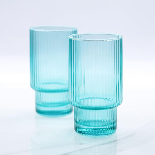 Two tall glass ribbed aqua drinking glasses