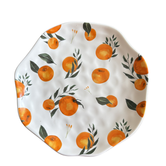Decorative plate with orange and leaf pattern on a white background