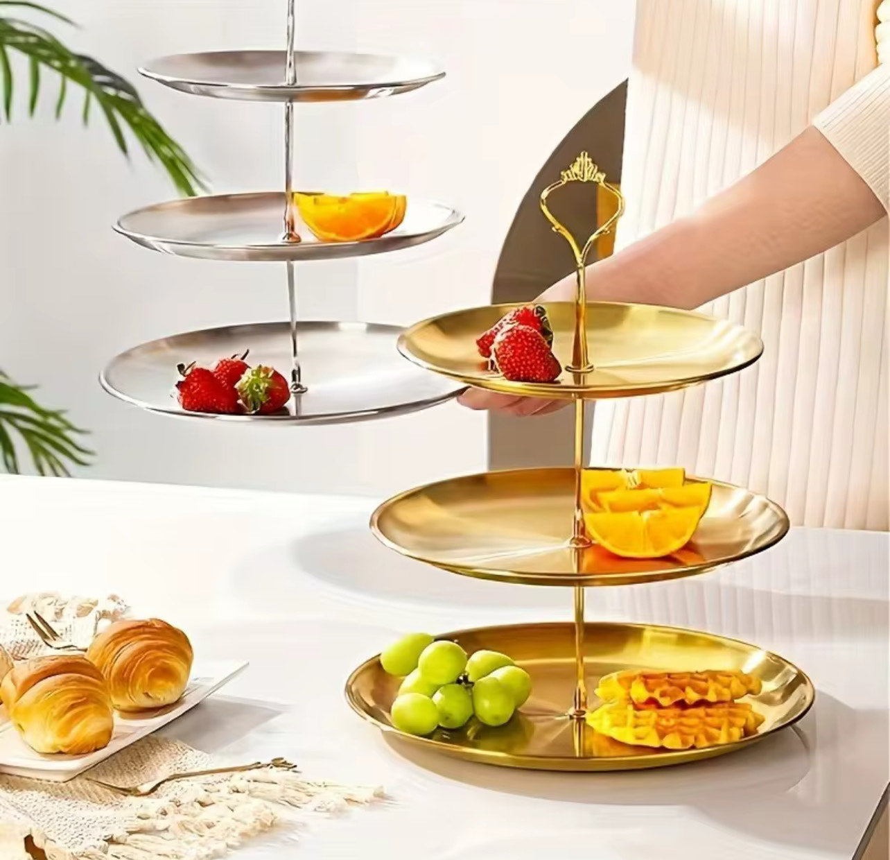 A three-tier golden aluminium cake stand with a central metal pillar and a decorative crown-shaped handle - Birdy Home Design