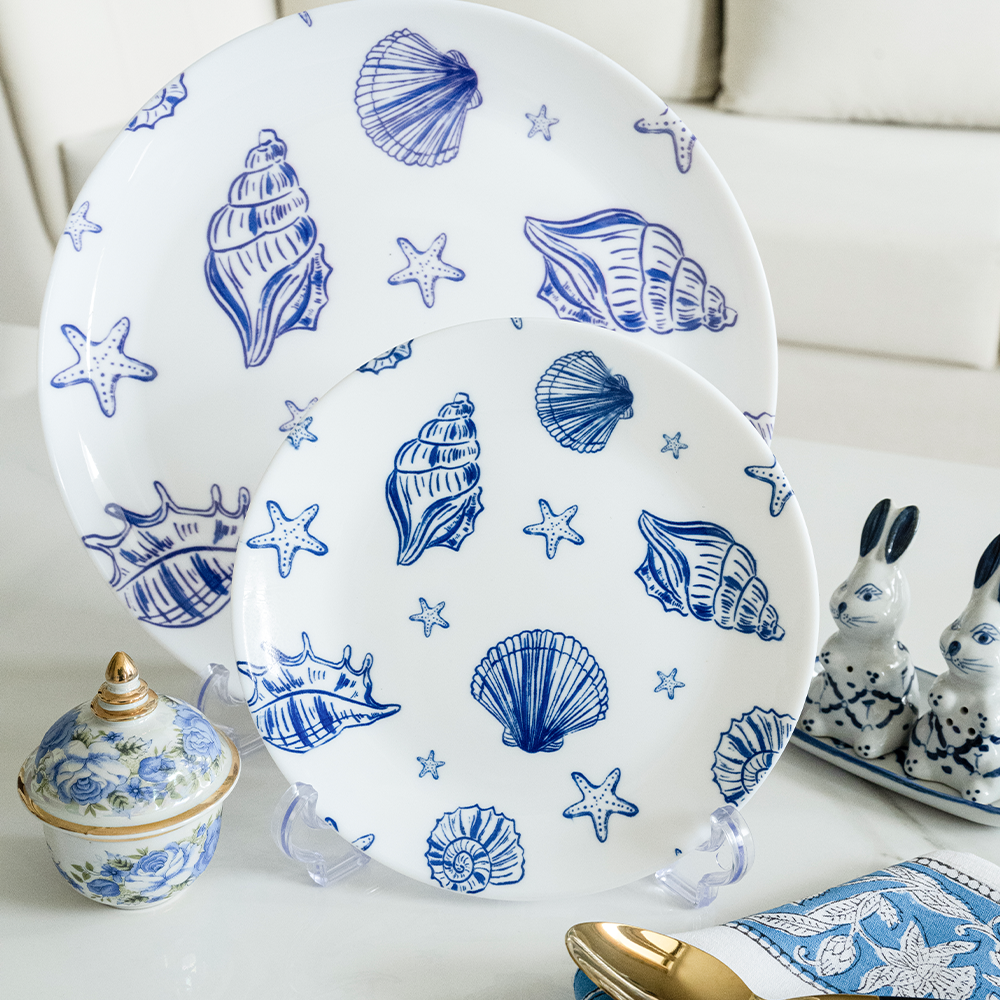 Bone china dinner and quarter plates featuring blue nautical shell and starfish designs