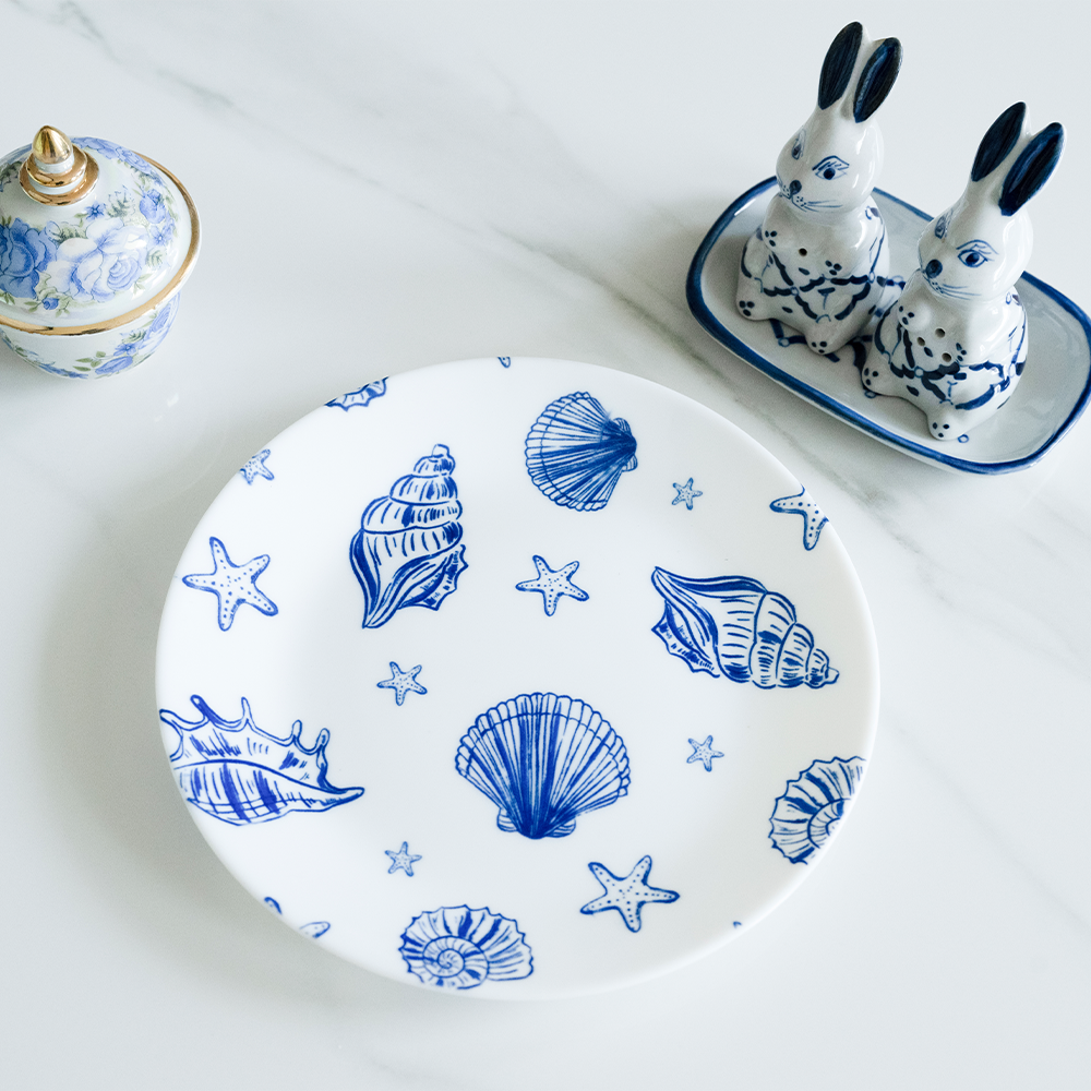 Bone china quarter plate featuring a blue nautical pattern of seashells and starfish
