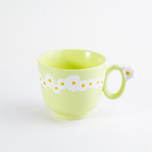 Yellow bone china cappuccino mug featuring embossed white daisy patterns and a flower detail on the handle - Birdy Home Design