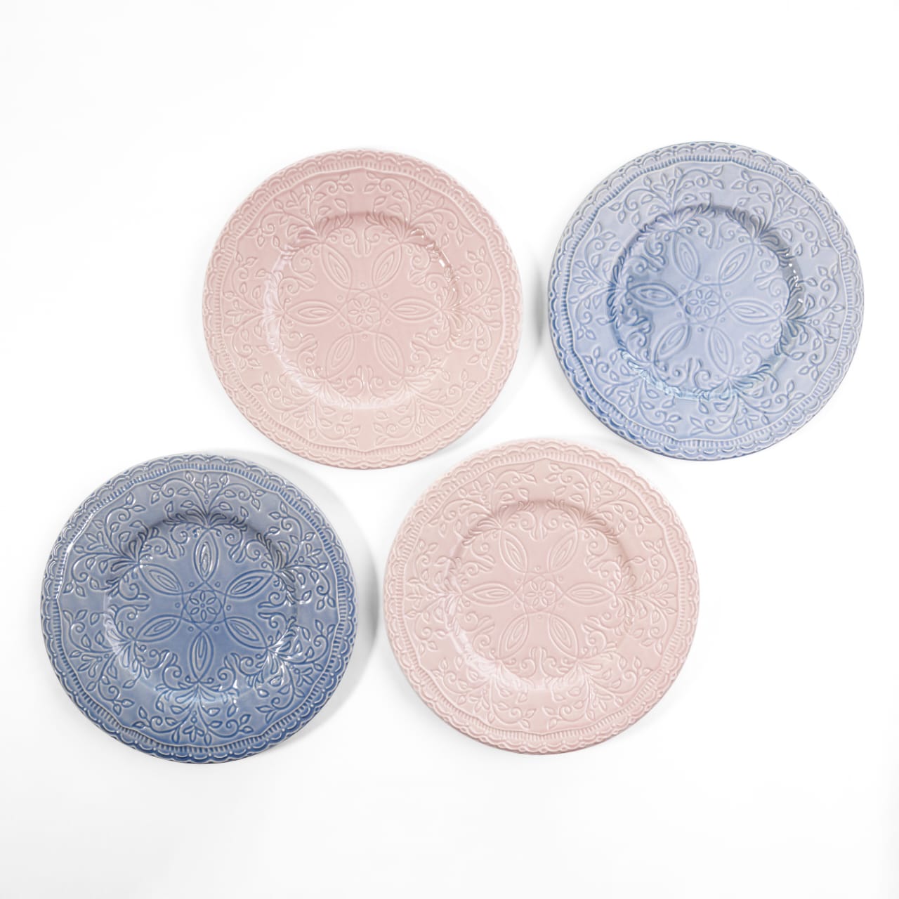 A top-down view of four 7.5-inch bone china quarter plates in pastel pink and blue, featuring intricate engraved floral carvings