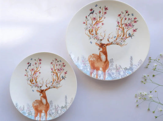 A set of two white bone china plates, including one large dinner plate and one quarter plate, featuring a vintage deer illustration with pink floral antlers - Birdy Home Design