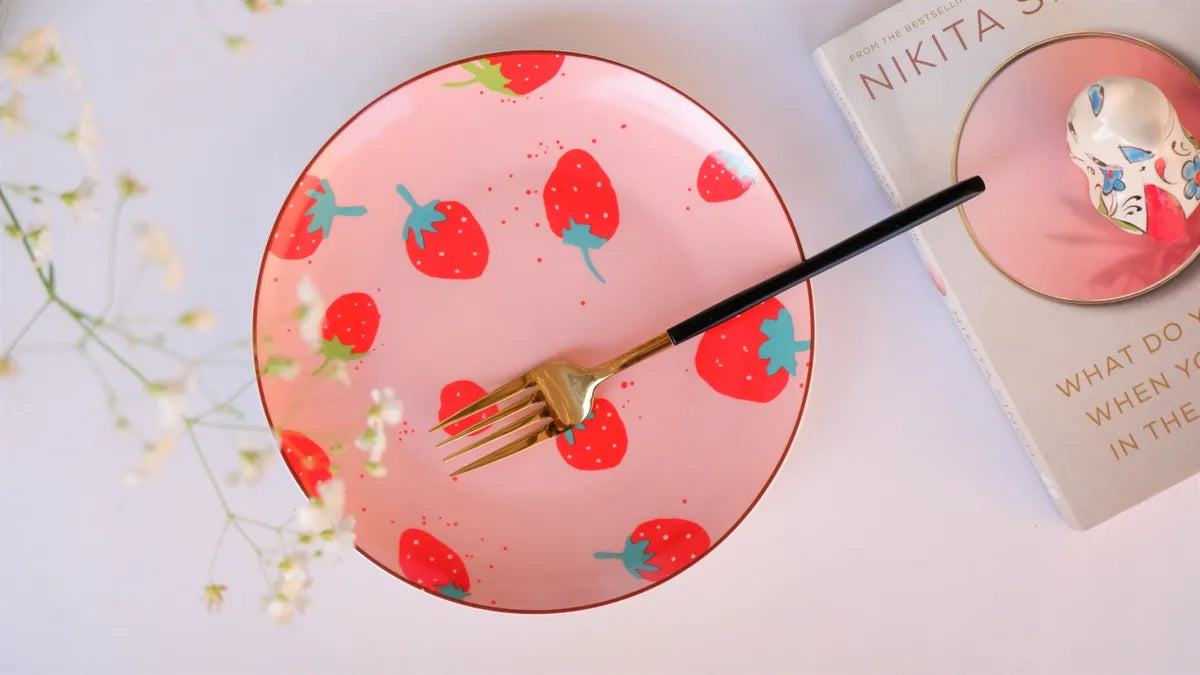 A top-down view of an 8-inch bone china plate featuring a vibrant red strawberry pattern