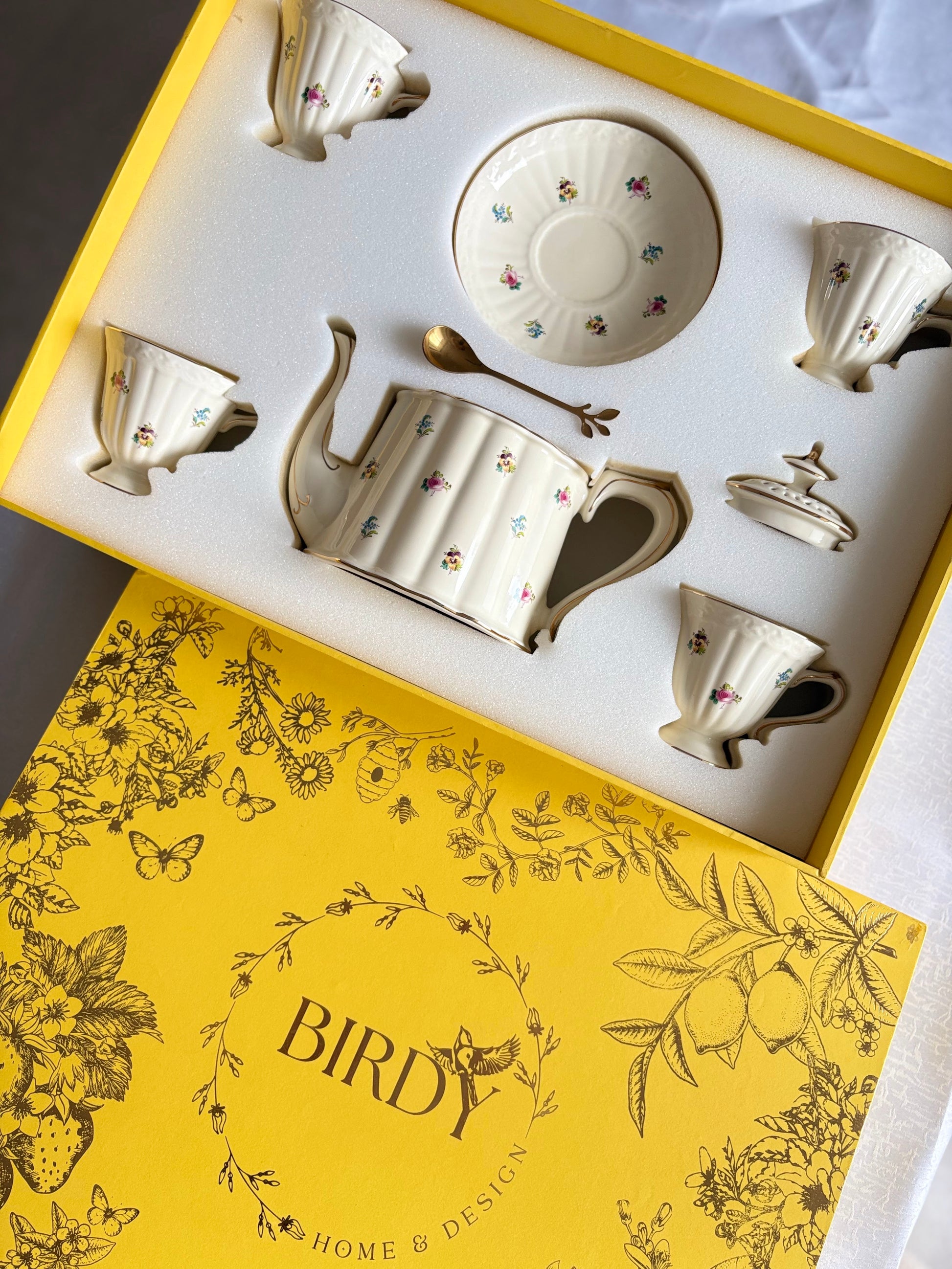 Bone china daisy fields tea set with teapot, 4 cups, saucer and gold spoon in open Birdy yellow botanical gift box