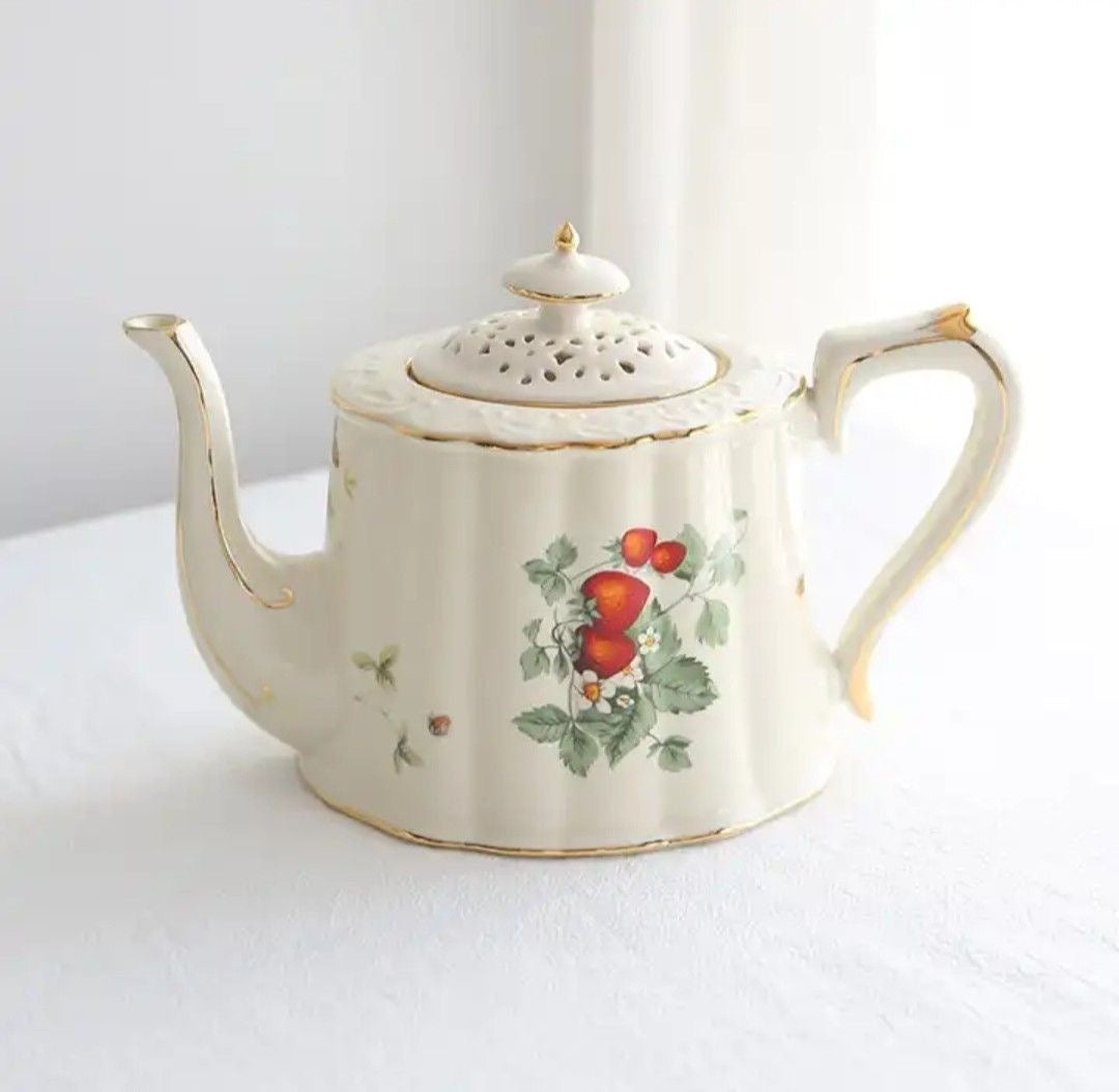 Bone china strawberries and cream teapot with strawberry motif, gold rim and lattice lid, front product shot