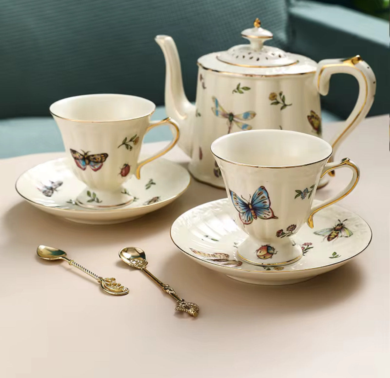 Bone china enchanted gardens teapot, two cups and saucers with butterfly and dragonfly motif, gold rim and two gold spoons