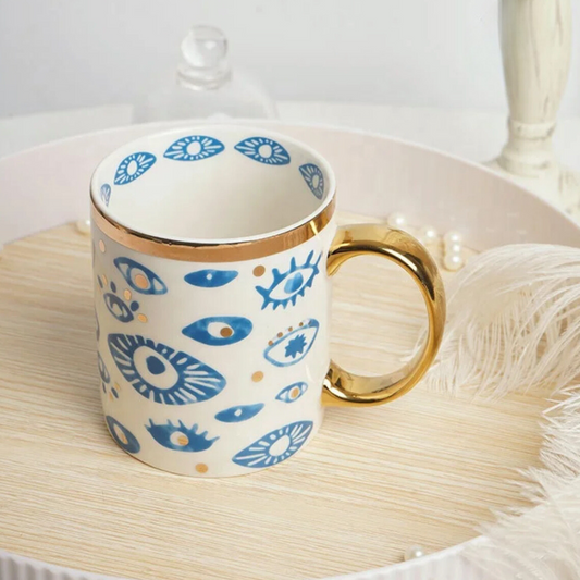 Bone china Turkish Evil Eye mug with blue eye patterns and a gold handle - Birdy Home Design