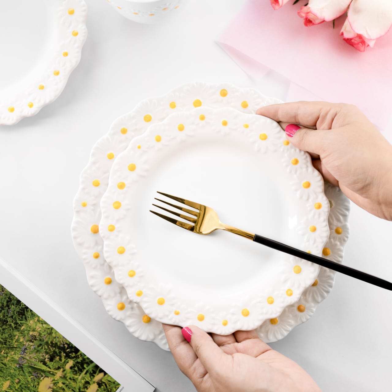 White bone china dinner and quarter plates with scalloped edges and embossed daisy flower patterns with yellow centers