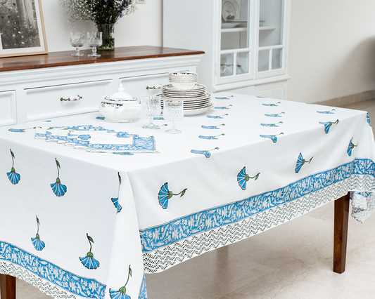 A white cotton table cloth featuring traditional blue floral block print motifs and an intricate blue border - Birdy Home Design