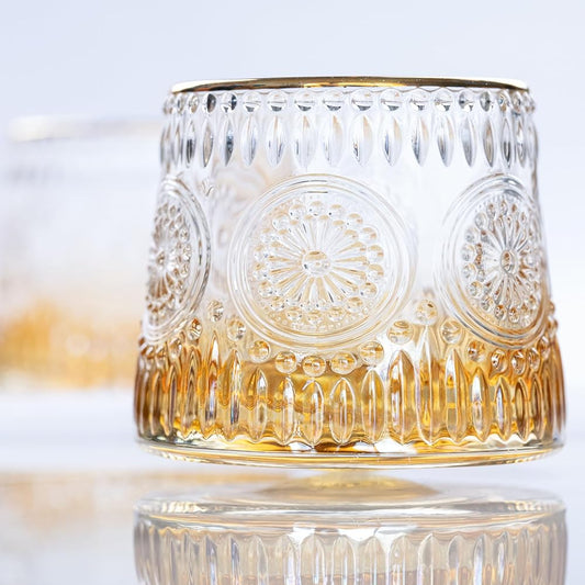 Crystal rotating whiskey glass with a gold rim and intricate patterns - Birdy Home Design