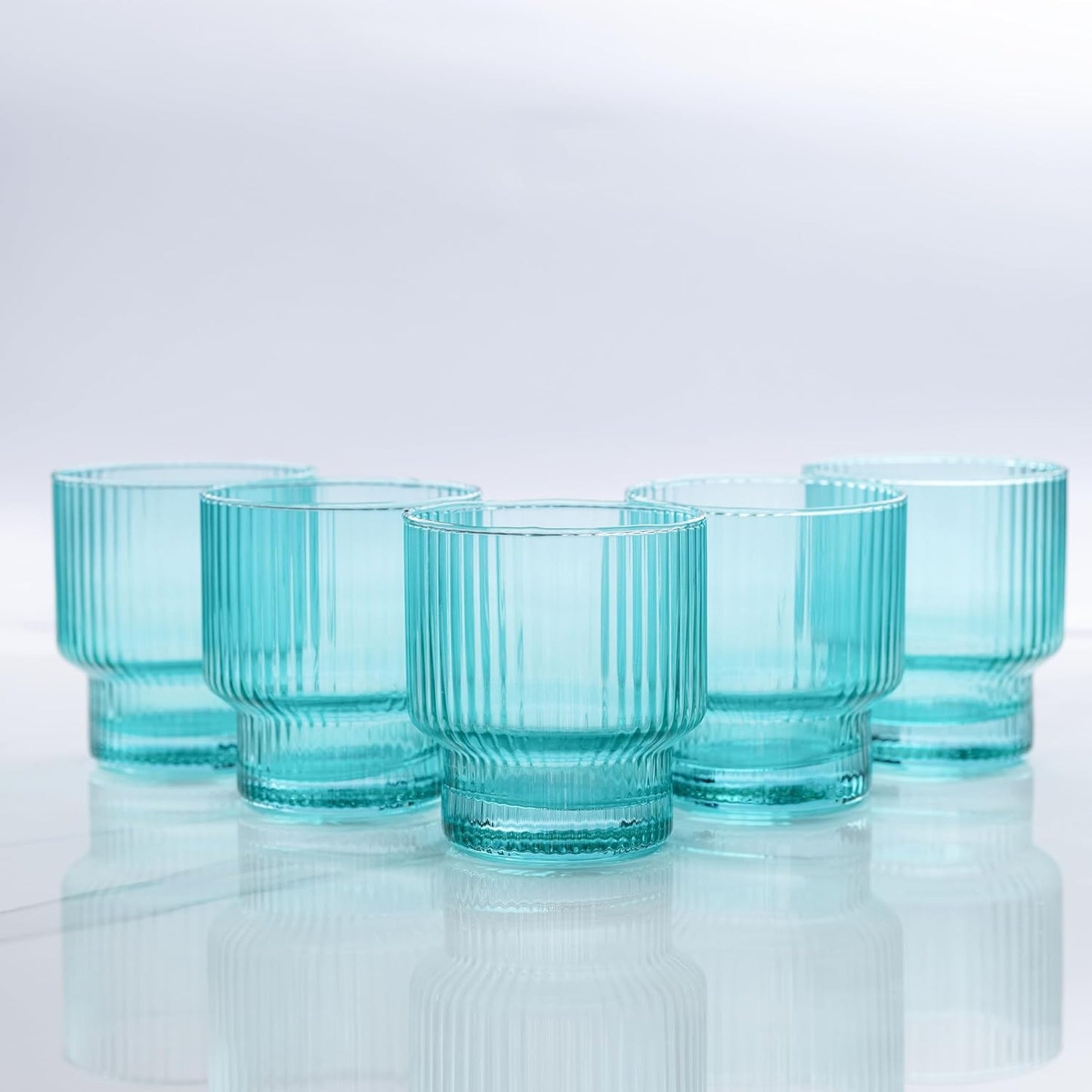 Five small glass ribbed aqua drinking glasses